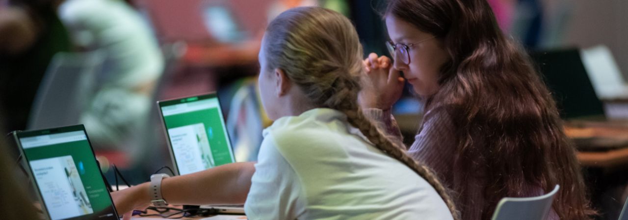 2 Mädchen an Laptops.
